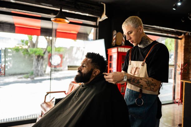 Barber putting a cape on the customer at a barber shop